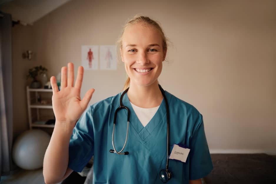 Nurse waving at camera