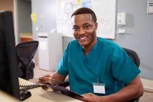 Male nurse reviewing paperwork